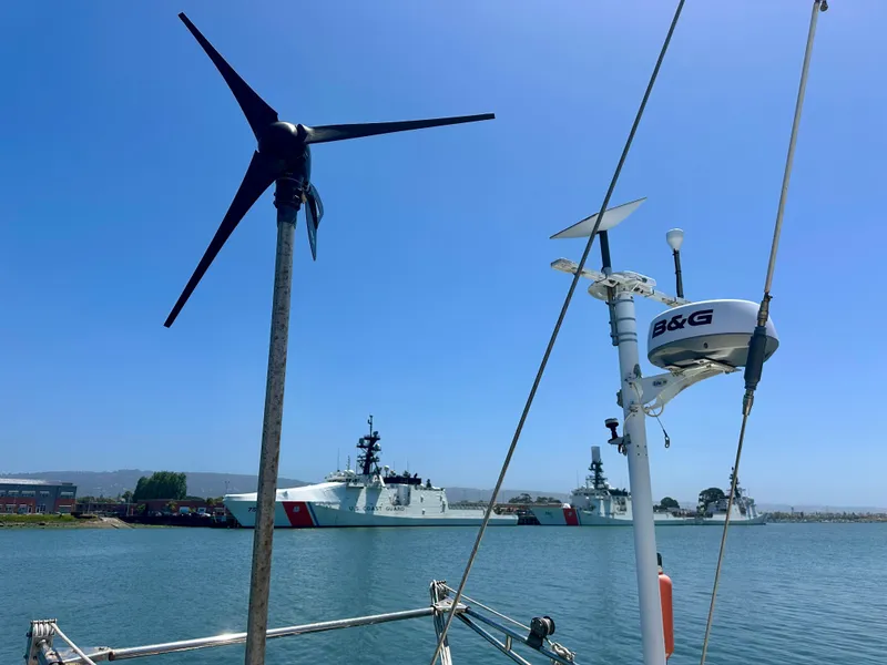 Slide: The Image of Sailboat with wind turbine and radar, Tayana 55, 1983, near coast guard ships. - 12