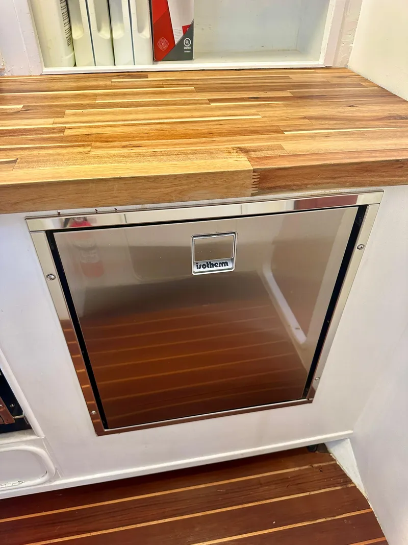 Slide: The Image of Stainless steel fridge on Tayana 55 yacht, 1983 model, with wooden countertop and flooring. - 25