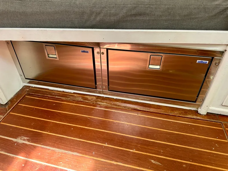 Slide: The Image of Stainless steel storage compartments on 1983 Tayana 55 yacht with wooden flooring. - 26