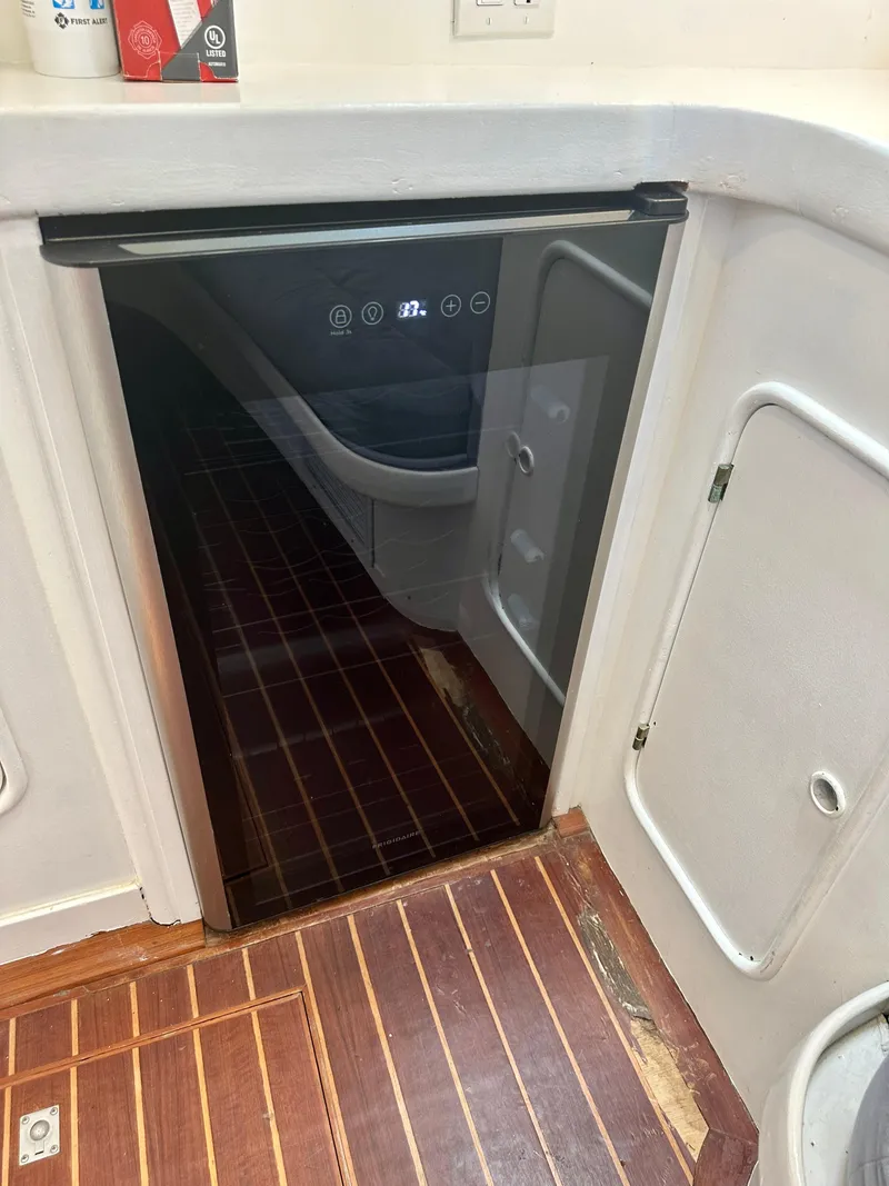 Slide: The Image of Compact refrigerator in 1983 Tayana 55 yacht interior with wooden flooring. - 27