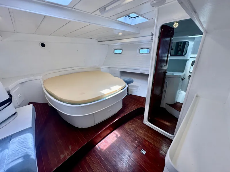 Slide: The Image of Interior of 1983 Tayana 55 yacht with spacious cabin and wooden flooring. - 28