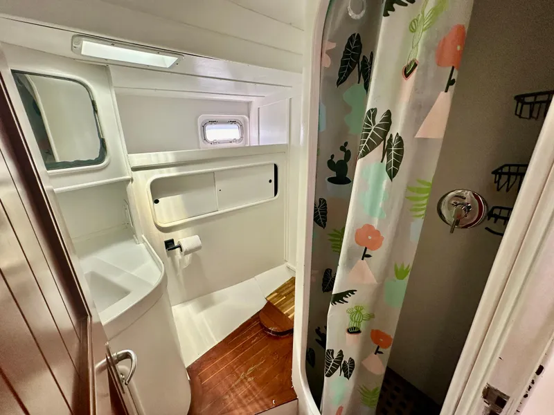Slide: The Image of Bathroom interior of 1983 Tayana 55 yacht with shower and wooden flooring. - 32