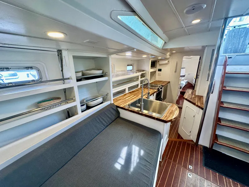 Slide: The Image of Interior of 1983 Tayana 55 yacht with modern kitchen and cozy seating area. - 37