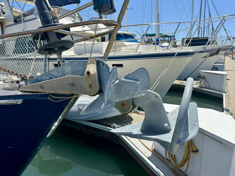 Slide: The Image of Anchor of 1983 Tayana 55 sailboat docked in marina. - 43