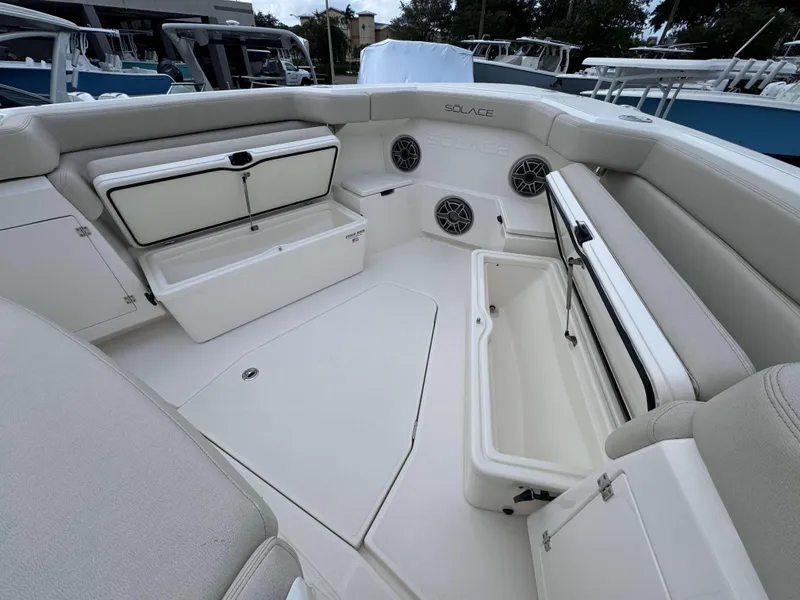 Slide: The Image of Interior of 2025 Solace 41 CS boat with open storage compartments and seating. - 11