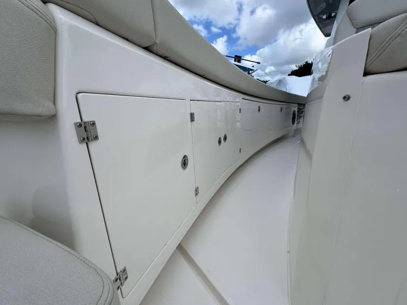 Slide: The Image of Interior view of 2025 Solace 41 CS boat with white storage compartments. - 14