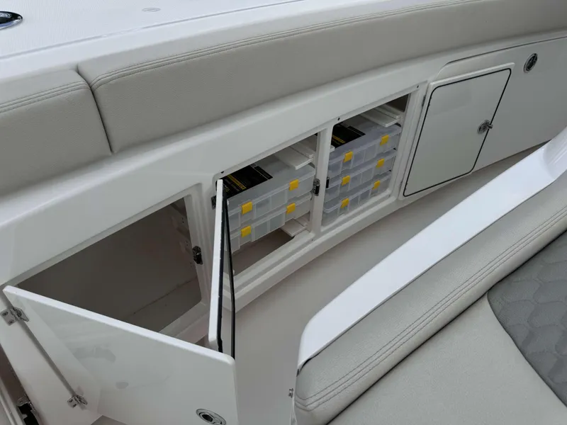 Slide: The Image of Storage compartments on the 2025 Solace 41 CS boat, featuring organized tackle boxes. - 16