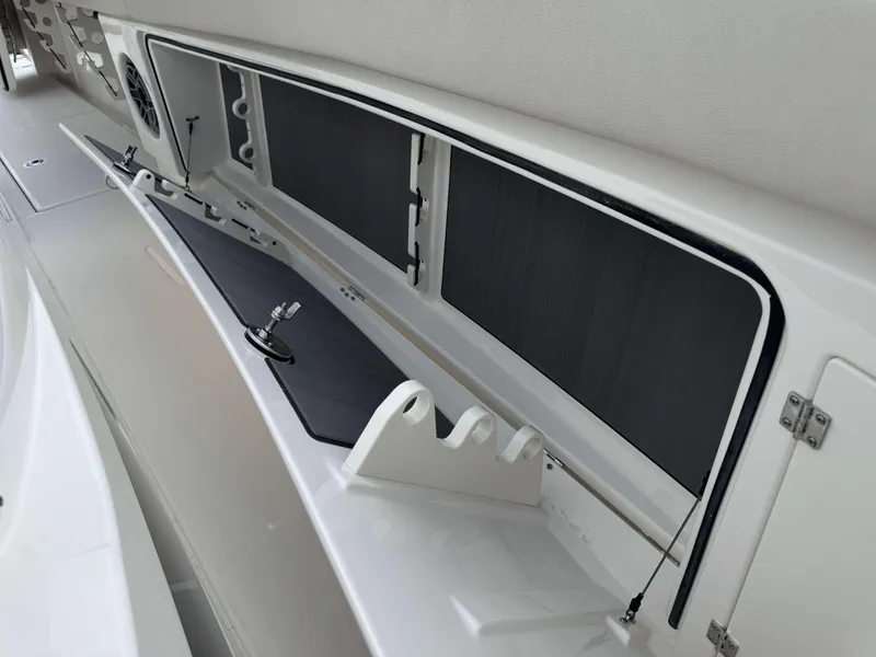 Slide: The Image of Interior storage compartment of 2025 Solace 41 CS boat with rod holders and tackle station. - 19