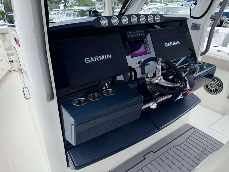 Slide: The Image of 2025 Solace 41 CS boat helm with Garmin navigation displays and steering wheel. - 21