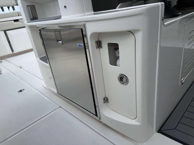 Slide: The Image of Stainless steel refrigerator and storage compartment on Solace 41 CS boat, 2025 model. - 25