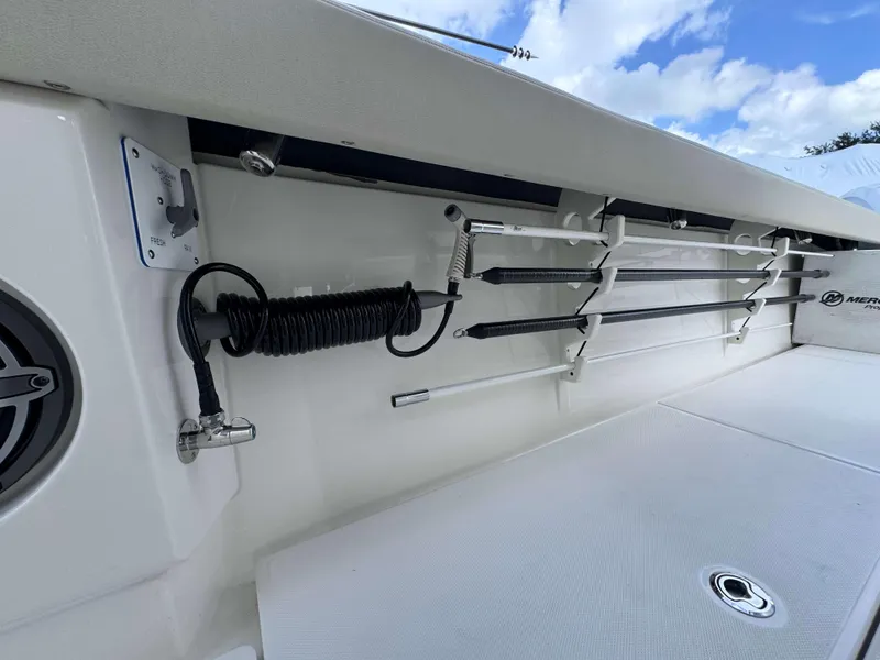 Slide: The Image of 2025 Solace 41 CS boat interior with rod holders and coiled hose. - 26
