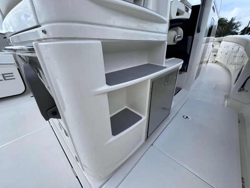 Slide: The Image of 2025 Solace 41 CS boat interior with storage compartments and stainless steel door. - 27