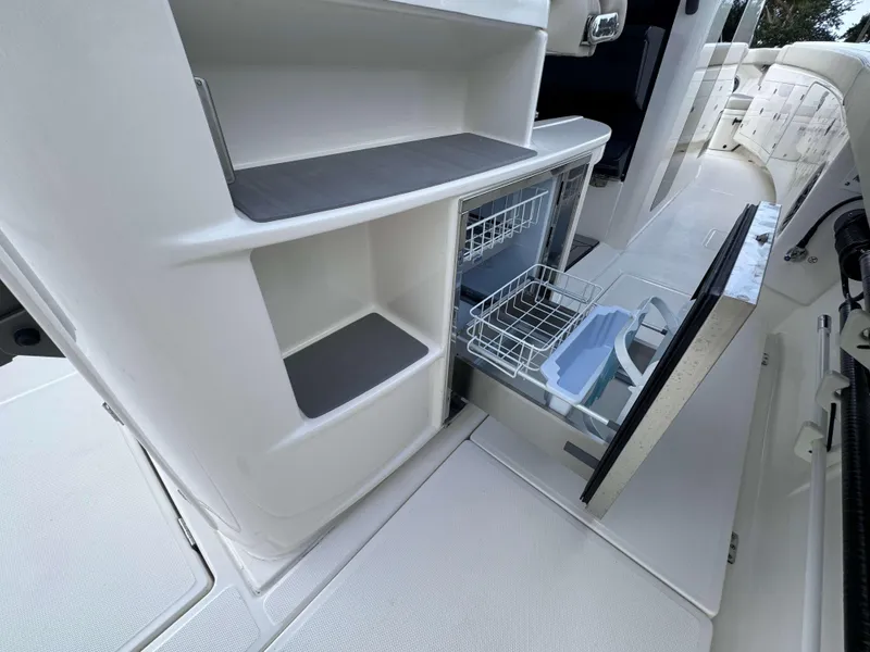 Slide: The Image of Solace 41 CS 2025 boat interior with open dishwasher and storage compartments. - 28