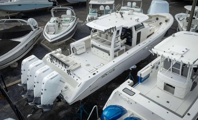 Slide: The Image of 2025 Solace 41 CS boat with four Mercury outboard engines in a marina. - 3