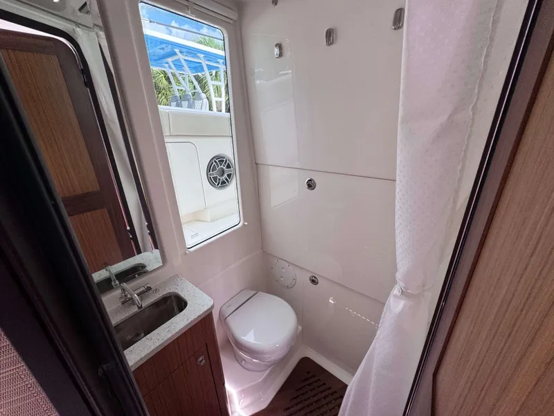 Slide: The Image of Bathroom interior of 2025 Solace 41 CS boat with sink, toilet, and window. - 36
