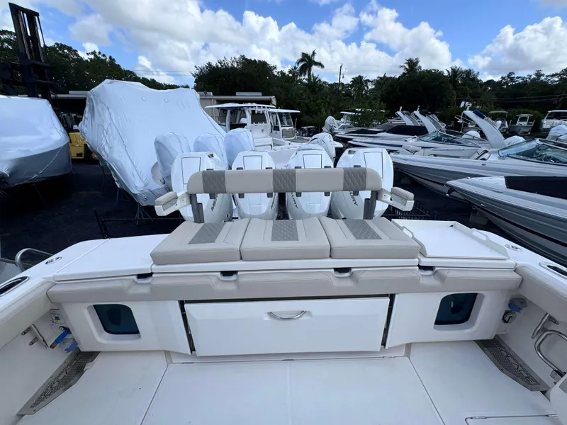 Slide: The Image of 2025 Solace 41 CS boat with cushioned seating and multiple outboard engines. - 41