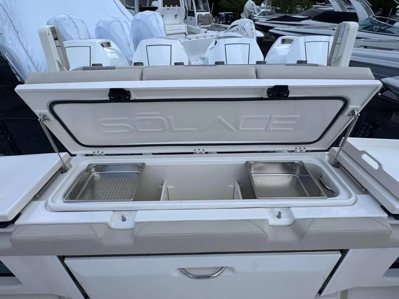 Slide: The Image of Open storage compartment on a 2025 Solace 41 CS boat. - 43