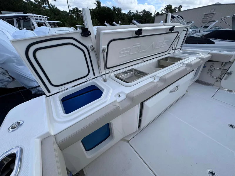 Slide: The Image of Open storage compartments on a 2025 Solace 41 CS boat. - 46