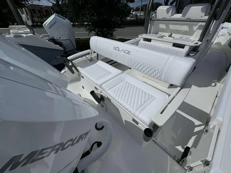 Slide: The Image of 2025 Solace 41 CS boat with Mercury engine and white cushioned seating. - 5