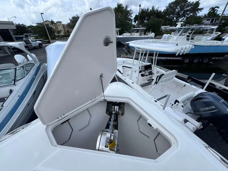 Slide: The Image of 2025 Solace 41 CS boat with open anchor locker, docked among other boats. - 8