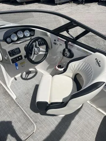 Slide: The Image of 2020 Stingray 208LR boat cockpit with steering wheel and control panel. - 10