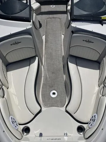 Slide: The Image of 2020 Stingray 208LR boat interior with cushioned seating and carpeted floor. - 15