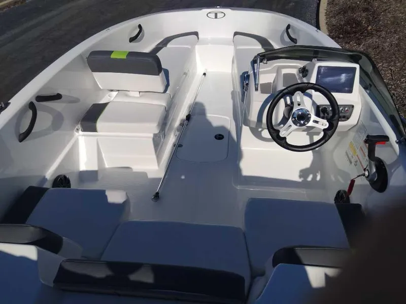 Slide: The Image of 2024 Tahoe T16 boat interior with steering wheel and seating arrangement. - 2