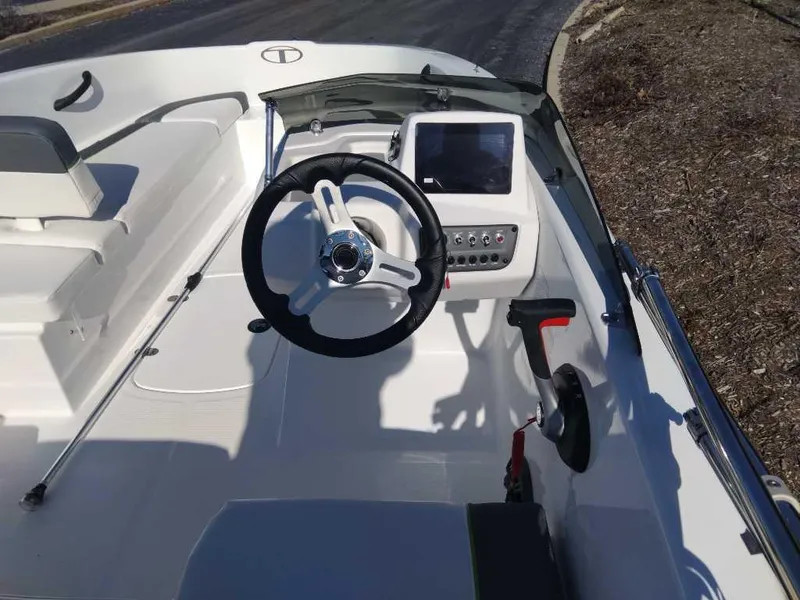 Slide: The Image of 2024 Tahoe T16 boat cockpit with steering wheel and control panel. - 3
