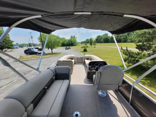 Slide: The Image of 2024 Sun Tracker Party Barge 20 DLX pontoon boat interior with seating and steering console. - 3