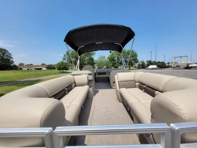 Slide: The Image of 2024 Sun Tracker Party Barge 20 DLX pontoon boat with beige seating and black canopy. - 4