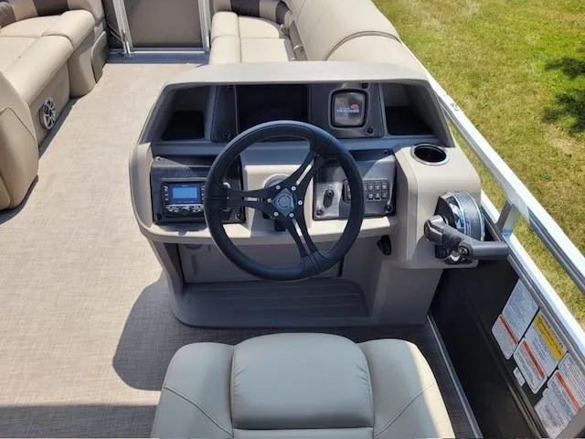 Slide: The Image of 2024 Sun Tracker Party Barge 20 DLX pontoon boat helm with steering wheel and controls. - 5