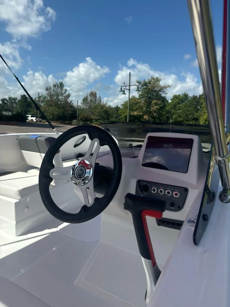 Slide: The Image of 2024 Tahoe T18 boat cockpit with steering wheel and control panel. - 8