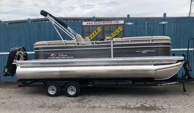 Slide: The Image of 2024 Sun Tracker Party Barge 22 XP3 pontoon boat on trailer. - 2