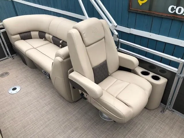 Slide: The Image of 2024 Sun Tracker Party Barge 22 XP3 interior with beige seating and cup holders. - 22