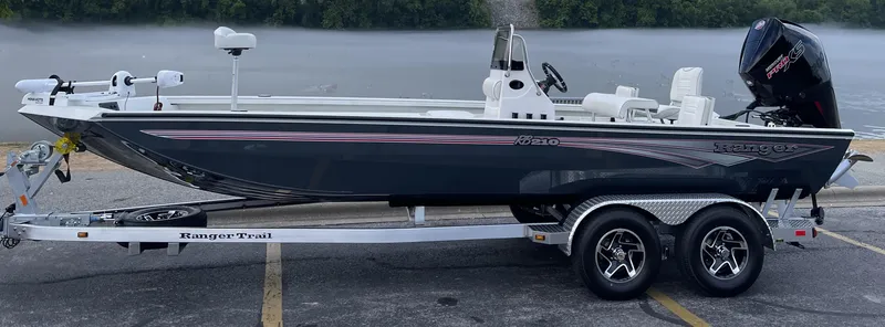 The Image of 2024 Ranger RB210 boat on trailer by the water. - 0