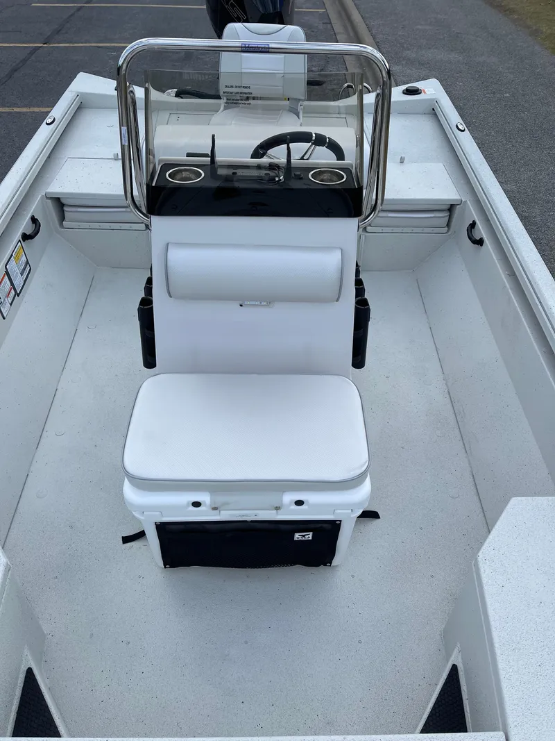 Slide: The Image of 2024 Ranger RB210 boat interior with steering console and seating. - 6