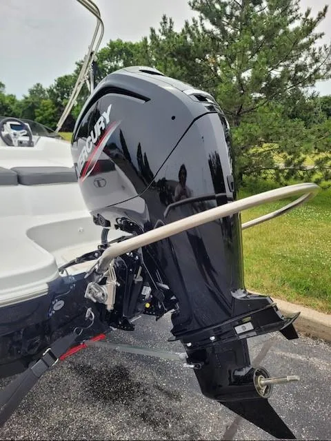 Slide: The Image of 2024 Tahoe T16 boat with Mercury outboard motor in a park setting. - 2