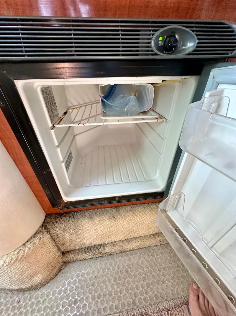 Slide: The Image of Open mini fridge inside 2003 Sea Ray 290 Amberjack boat cabin. - 19