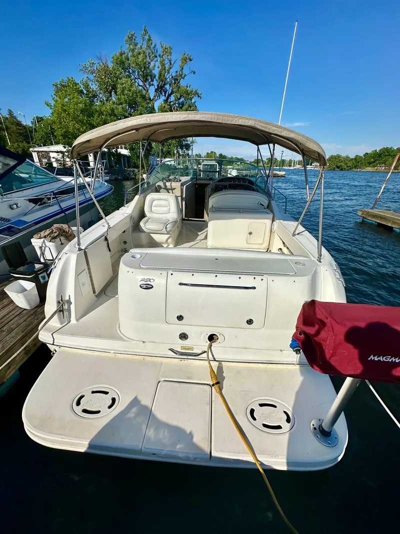 Slide: The Image of 2003 Sea Ray 290 Amberjack boat docked on a sunny day. - 2