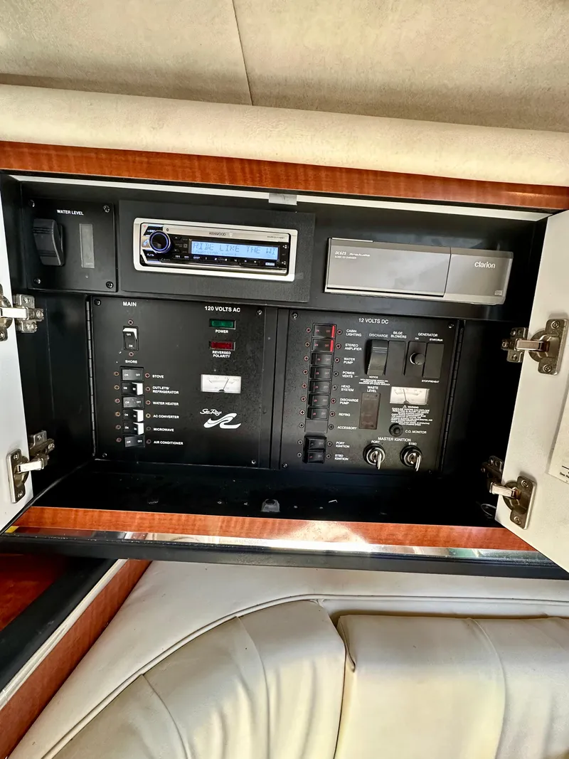 Slide: The Image of Control panel inside 2003 Sea Ray 290 Amberjack boat, featuring audio system and switches. - 20