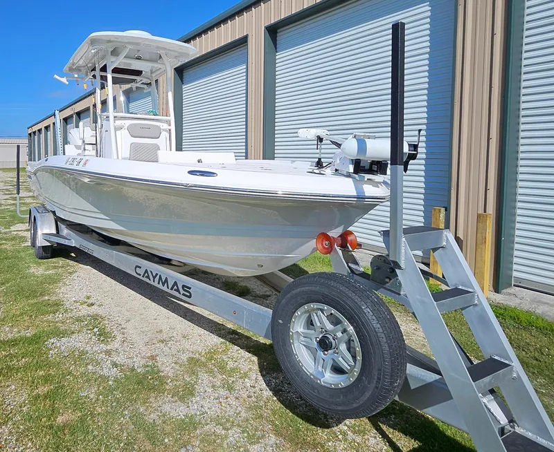 Slide: The Image of 2024 Caymas 26HB boat on a trailer outside a storage facility. - 1