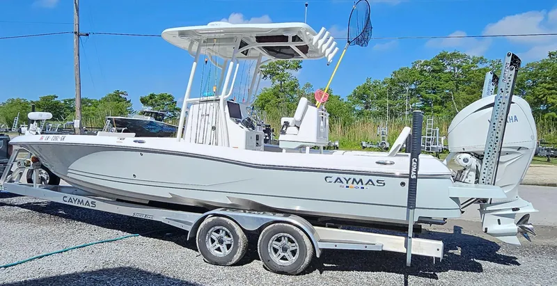 Slide: The Image of 2024 Caymas 26HB boat on a trailer, side view, outdoors. - 2
