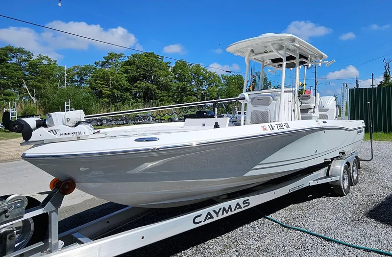 Slide: The Image of 2024 Caymas 26HB boat on trailer, white hull, outdoor setting. - 4