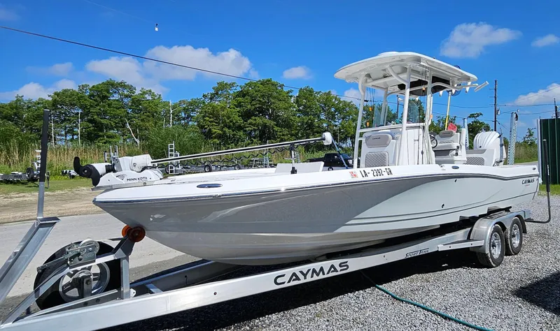 Slide: The Image of 2024 Caymas 26HB boat on a trailer, parked outdoors under a clear blue sky. - 5