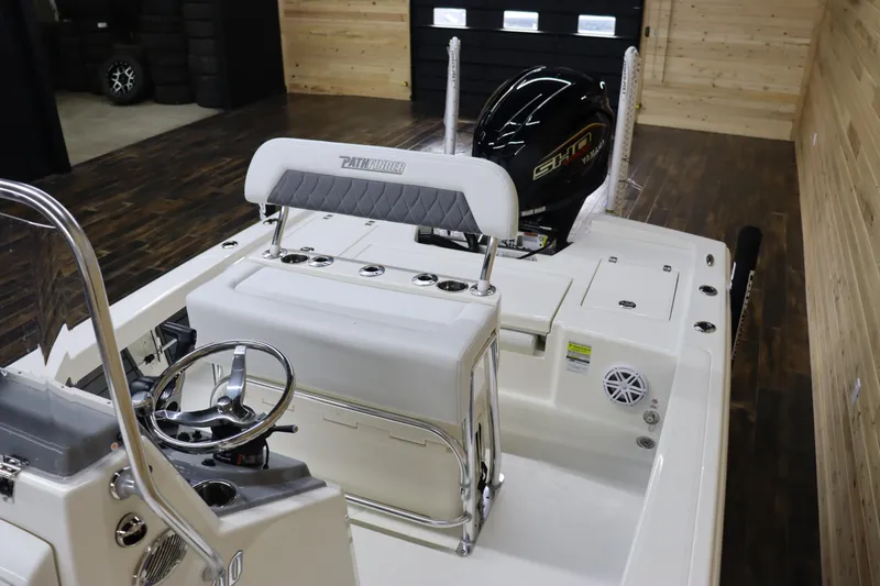 Slide: The Image of 2024 Pathfinder 2200 TRS boat interior with steering wheel and outboard motor. - 10