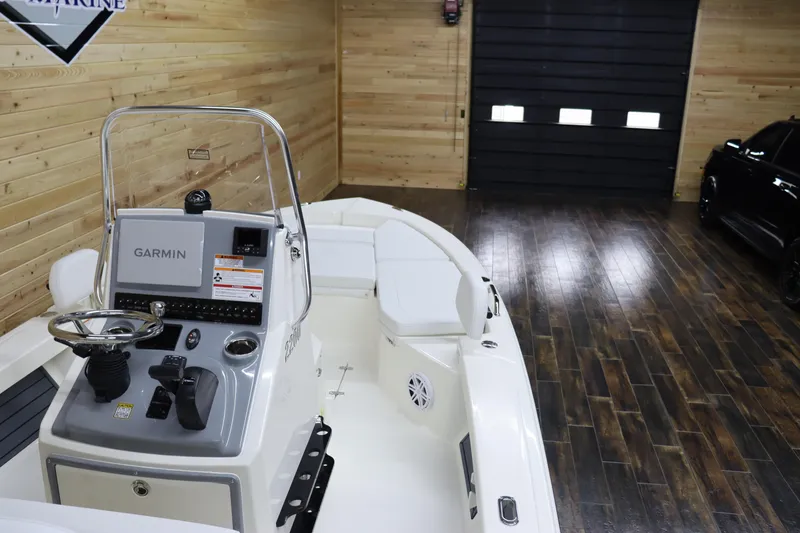 Slide: The Image of 2024 Pathfinder 2200 TRS boat with Garmin navigation system in a wooden garage. - 13