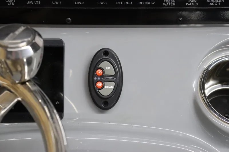 Slide: The Image of 2024 Pathfinder 2200 TRS boat control panel with up and down buttons. - 18