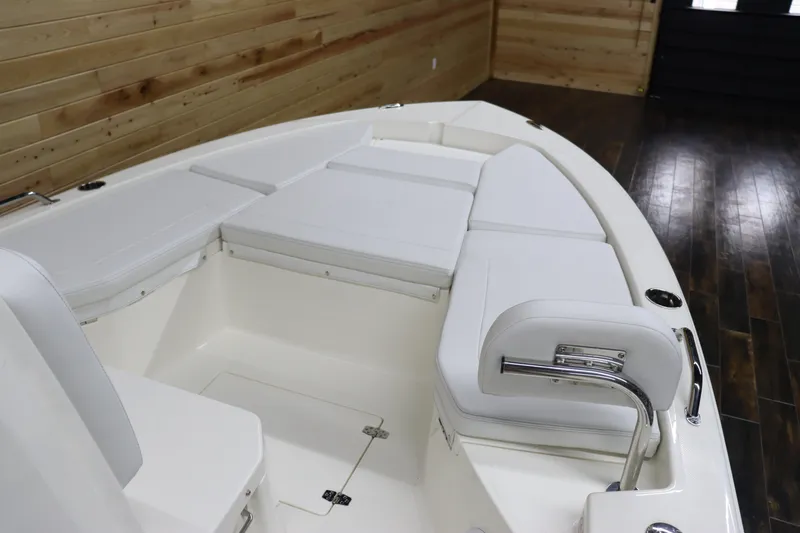 Slide: The Image of 2024 Pathfinder 2200 TRS boat interior with cushioned seating and storage compartments. - 19