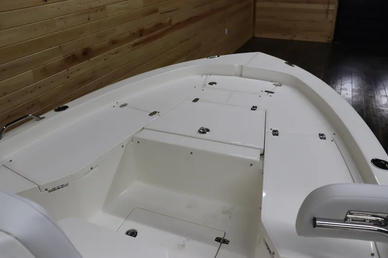 Slide: The Image of 2024 Pathfinder 2200 TRS boat interior with storage compartments and seating. - 23