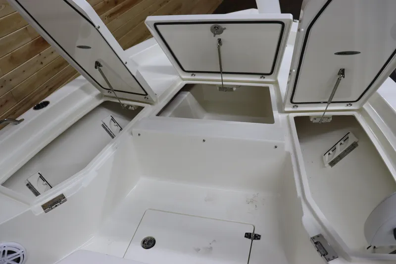 Slide: The Image of 2024 Pathfinder 2200 TRS boat storage compartments open. - 24
